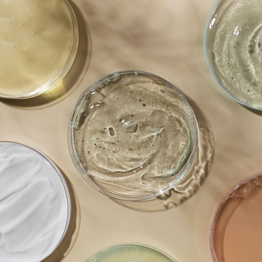 Various natural oils and creams on brown paper background