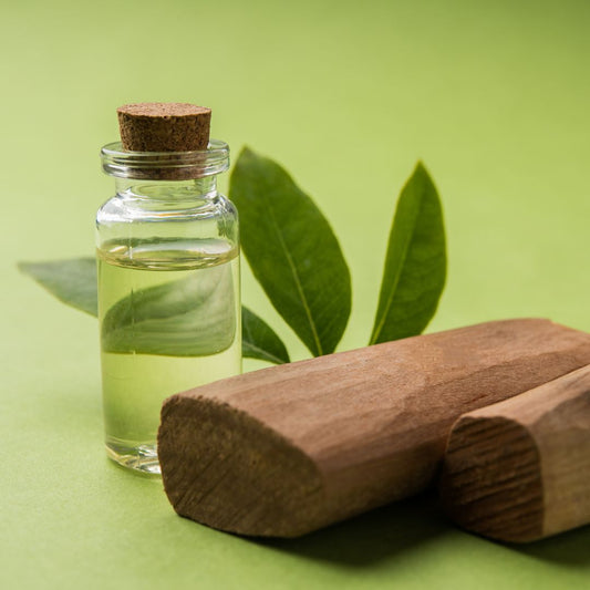 Small vial of natural oil in front of a lime green background